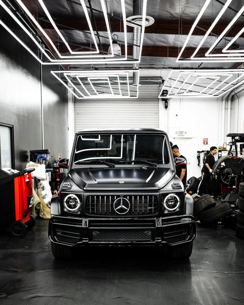 Front view of a luxury Mercedes-Benz SUV parked inside a sleek modern garage.