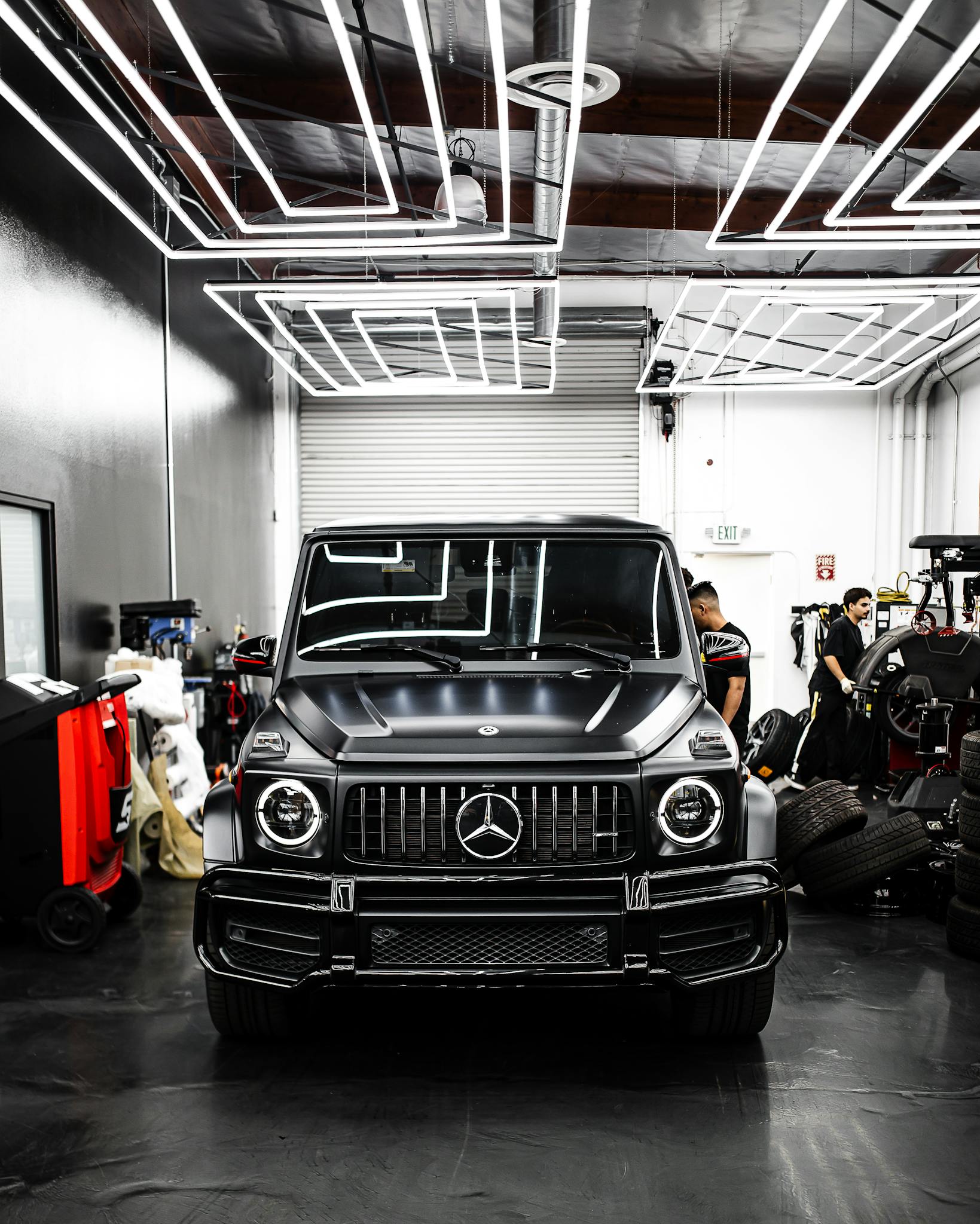 Mobile Detailing Winter Springs FL Front view of a luxury Mercedes-Benz SUV parked inside a sleek modern garage.