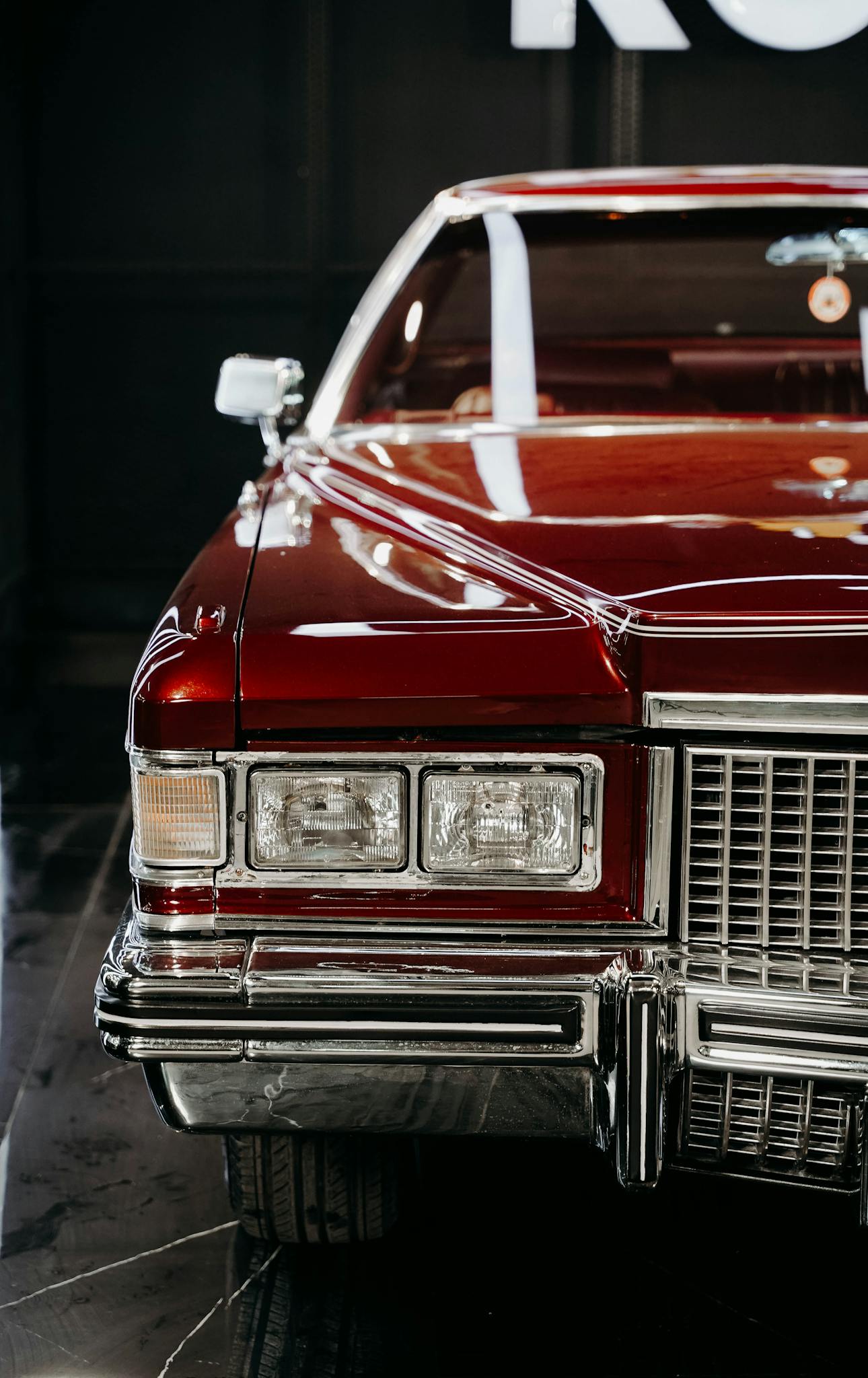 Mobile Detailing Winter Springs FL Front view of a vintage Cadillac with shiny chrome and classic headlight design, showcasing retro elegance.