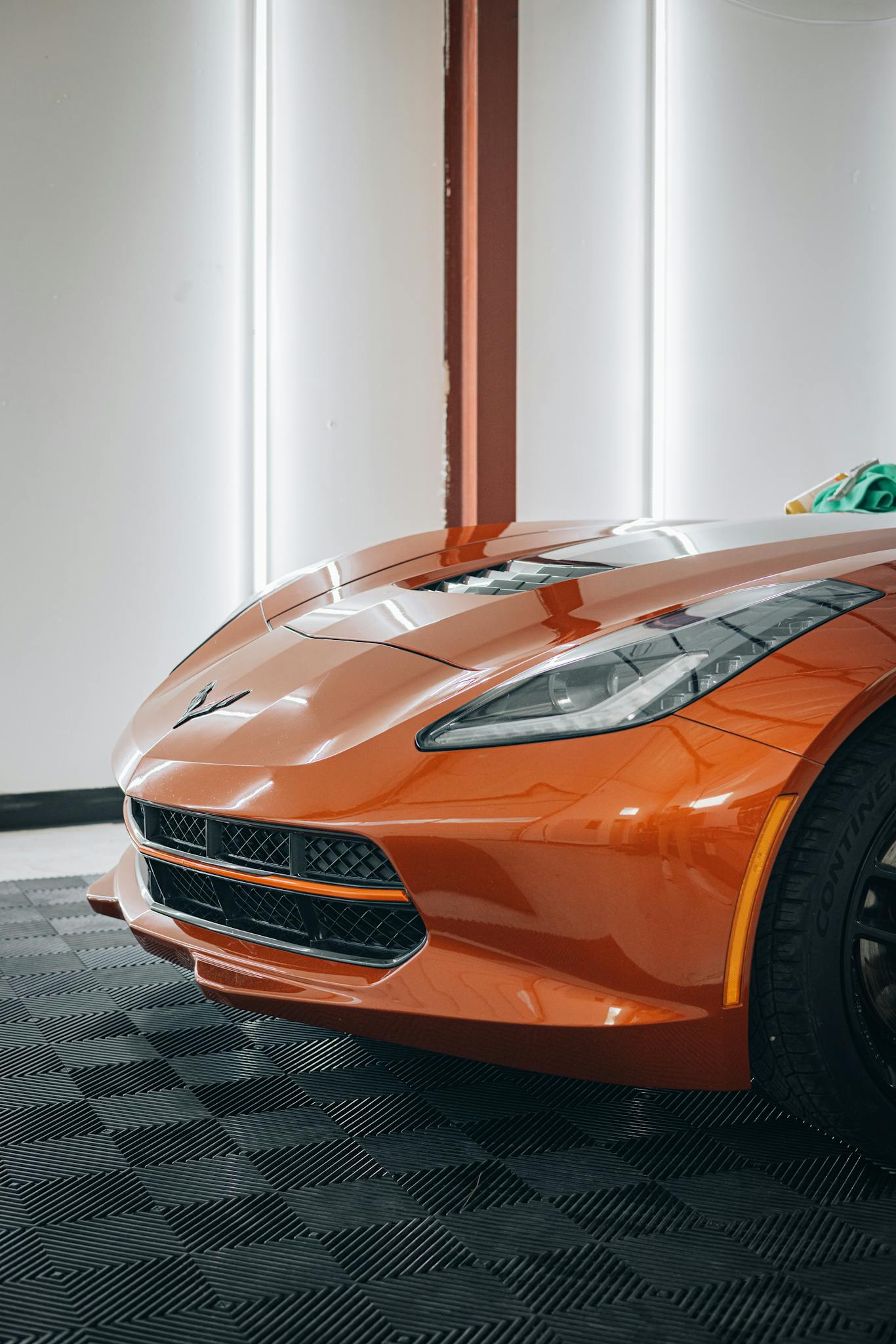 Mobile Detailing Winter Springs FL Close-up of a bright orange sports car gracing a modern showroom.