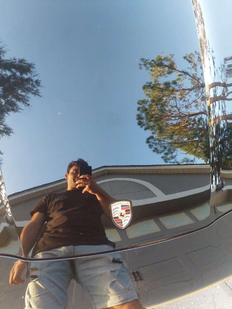 reflection in the mirror-like black paint of a Porsche Panamera in Waterford Lakes, FL